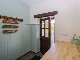 A hallway with a door and a welcome sign at Ewedale Farm, Pennington near Ulverston