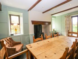 A dining room with a wooden table and chairs at Ewedale Farm Pennington near Ulverston