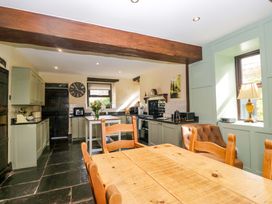 A kitchen with a table and chairs at Ewedale Farm in Pennington near Ulverston