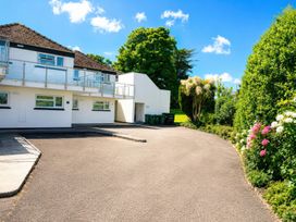 A building with a balcony and parking lot at 6 Coedrath Park - Swn y Mor Saundersfoot