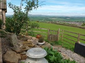 An outdoor area with a fence and gate at The Journeyman Luxury Shepherds Hut in Barnoldswick