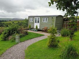 A shepherd's hut with a pathway and plants at The Journeyman Luxury Shepherds Hut in Barnoldswick
