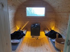 A sauna with wooden paneling and benches at The Journeyman Luxury Shepherds Hut Barnoldswick
