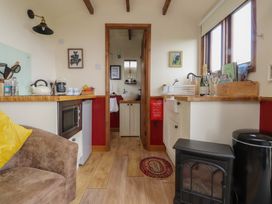 A kitchen with various appliances and furniture at The Journeyman Luxury Shepherds Hut in Barnoldswick