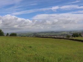 A landscape view with grass and hills at The Journeyman Luxury Shepherds Hut in Barnoldswick
