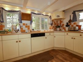 A kitchen with cabinets and a sink at Vi’s Valley View in Pentewan