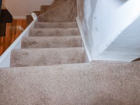 Stairs with carpet in a staircase at Vi’s Valley View Pentewan