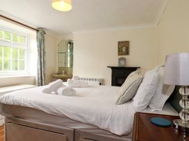 A bedroom with a bed and window at Vi’s Valley View in Pentewan