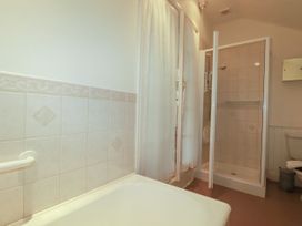 A bathroom featuring a bathtub, shower, and toilet at Vi’s Valley View, Pentewan
