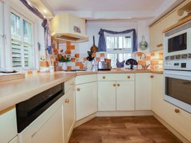 A kitchen with a sink and oven at Vi’s Valley View in Pentewan