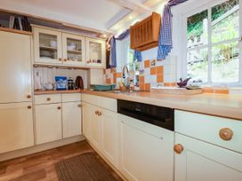 A kitchen with a sink and cupboards at Vi’s Valley View in Pentewan