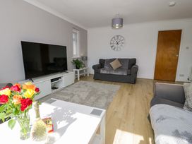 A living room with a television and sofa at Trem Y Foel in Penrhyndeudraeth