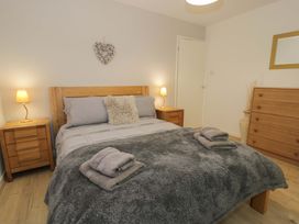A bedroom with a bed and nightstands at Trem Y Foel in Penrhyndeudraeth