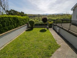 A garden with grass and a flower pot at Trem Y Foel in Penrhyndeudraeth