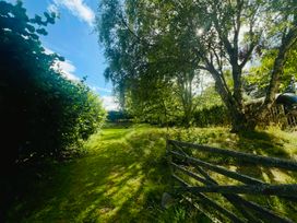 A garden path surrounded by trees at Skylarks in Ferintosh near to Dingwall