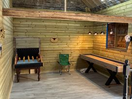 A game room with a games table and seating at Pen Bont Home Farm Upper Chapel near Builth Wells
