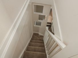 A staircase with windows and carpet at Crew House in Dartmouth