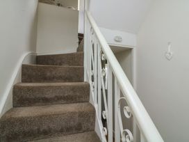 A staircase with carpet and handrail at Crew House in Dartmouth