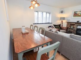 A dining room with a wooden table and chairs at Glen Lea in Giggleswick, Settle