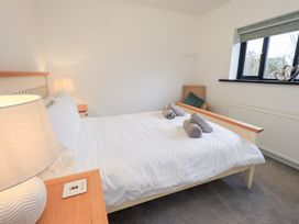 A bedroom with a bed and lamp at Glen Lea in Giggleswick, Settle