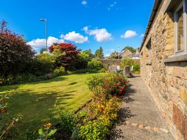 A garden with a pathway and furniture at Glen Lea in Giggleswick, Settle