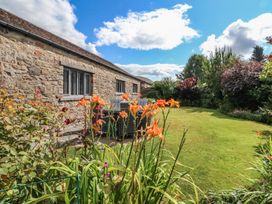 A garden with flowers and stone wall at Glen Lea in Giggleswick, Settle