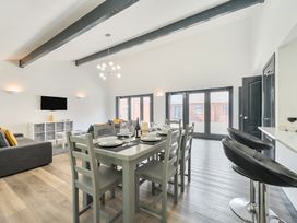 A living room with dining area and sofa at The Cottage in Wimborne Minster
