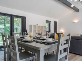 A dining room with a table set for dinner at The Cottage in Wimborne Minster