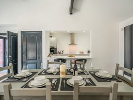 A dining room with a table set for dinner at The Cottage in Wimborne Minster