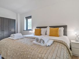 A bedroom with a bed and wardrobe at The Cottage in Wimborne Minster