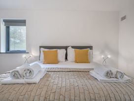 A bedroom with a bed and pillows at The Cottage in Wimborne Minster