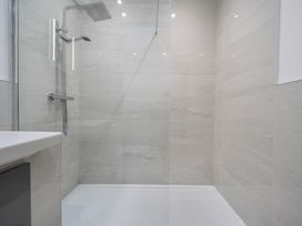 A shower area with a sink at The Cottage in Wimborne Minster