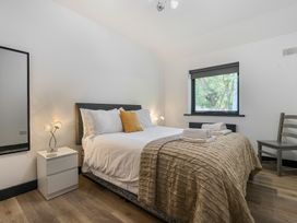 A bedroom with a bed and nightstand at The Cottage in Wimborne Minster