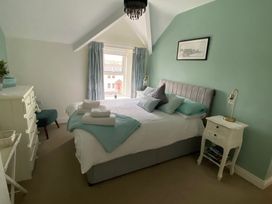 A bedroom with two beds and a window at 4 The Cloisters, Bushmills, County Antrim