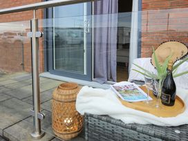 A balcony with a table tray and prosecco at Apartment 3 Trearddur Bay