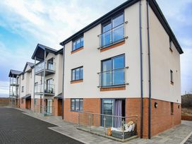 An apartment building with balconies at Apartment 3 in Trearddur Bay
