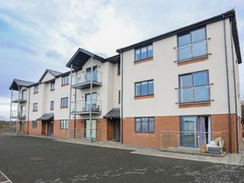 An apartment building with balconies and windows at Apartment 3 Trearddur Bay