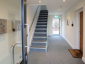 A hallway with a staircase and mailboxes at Apartment 3 Trearddur Bay