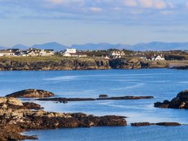 A coastal view with houses and mountains at Apartment 3 in Trearddur Bay