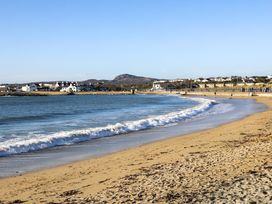 A beach with sand and water at Apartment 3 in Trearddur Bay