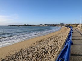 A beach with sand and water at Apartment 3 in Trearddur Bay