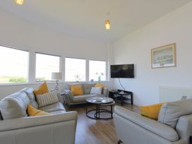 A living room with sofas and a coffee table at 11 Cove View Apartments in Ilfracombe