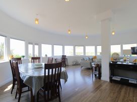A dining room with a table and chairs at 11 Cove View Apartments Ilfracombe