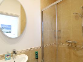 A bathroom with a shower and sink at 11 Cove View Apartments in Ilfracombe