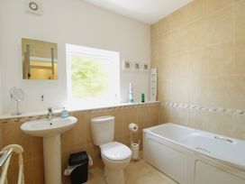 A bathroom with a sink, toilet, and bath at 11 Cove View Apartments in Ilfracombe