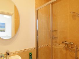 A bathroom with a shower and sink at 11 Cove View Apartments Ilfracombe