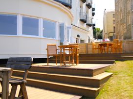An outdoor area with chairs and tables at 11 Cove View Apartments Ilfracombe