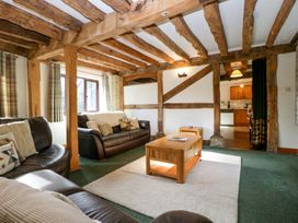 A living room with sofas and a coffee table at Redstart Cottage in Kingsland