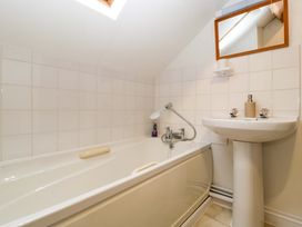 A bathroom with a bathtub and sink at Redstart Cottage in Kingsland