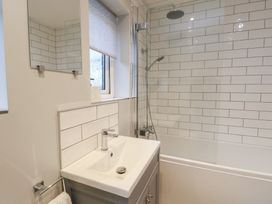 A bathroom with a sink and shower at Treestumps in Benllech